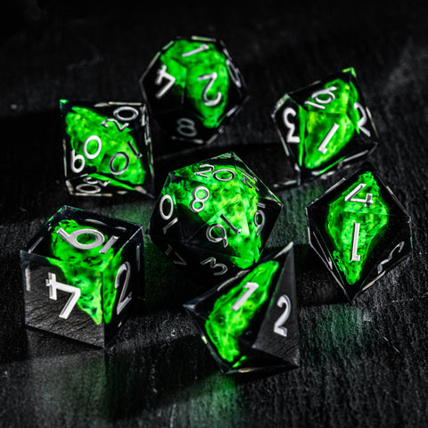 a group of green dices sitting on top of a table