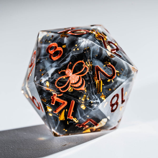 a black and orange dice with numbers on it