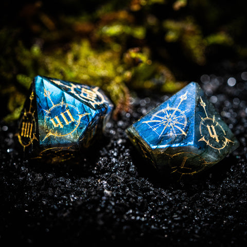 two blue dices sitting on top of a black surface