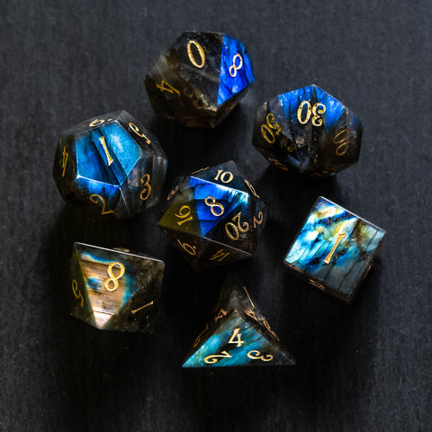 a group of blue and gold dice sitting on top of a table