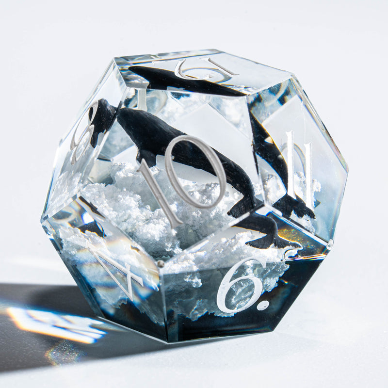 a clear diamond with a black and white fish on it