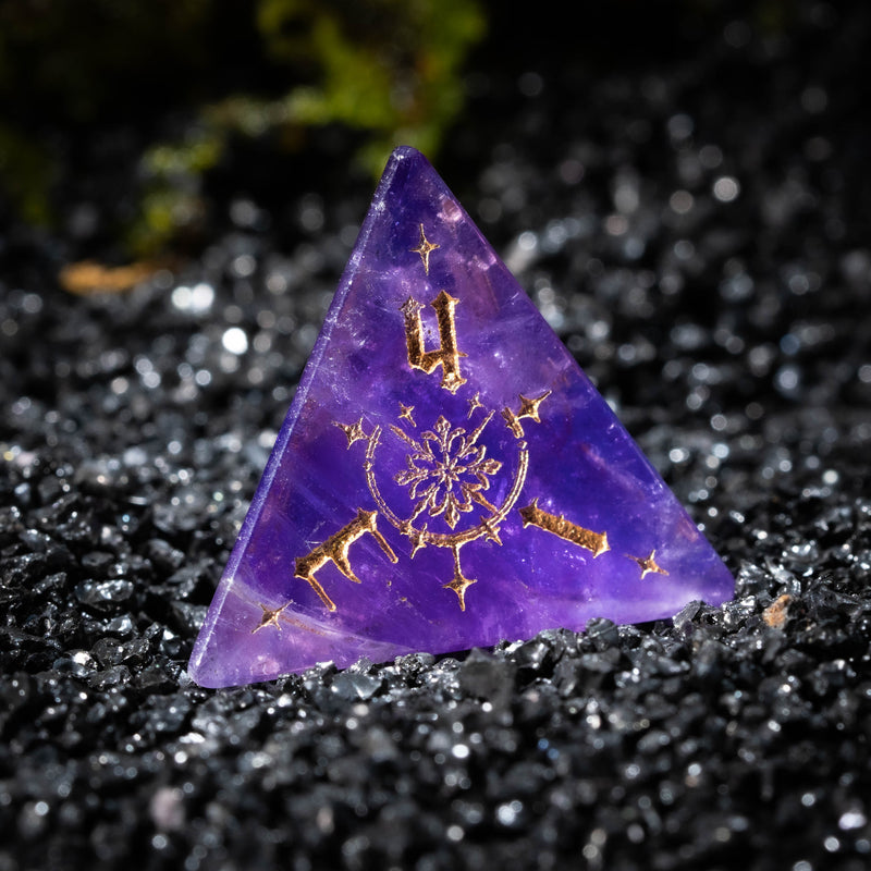 a purple triangle with a gold design on it