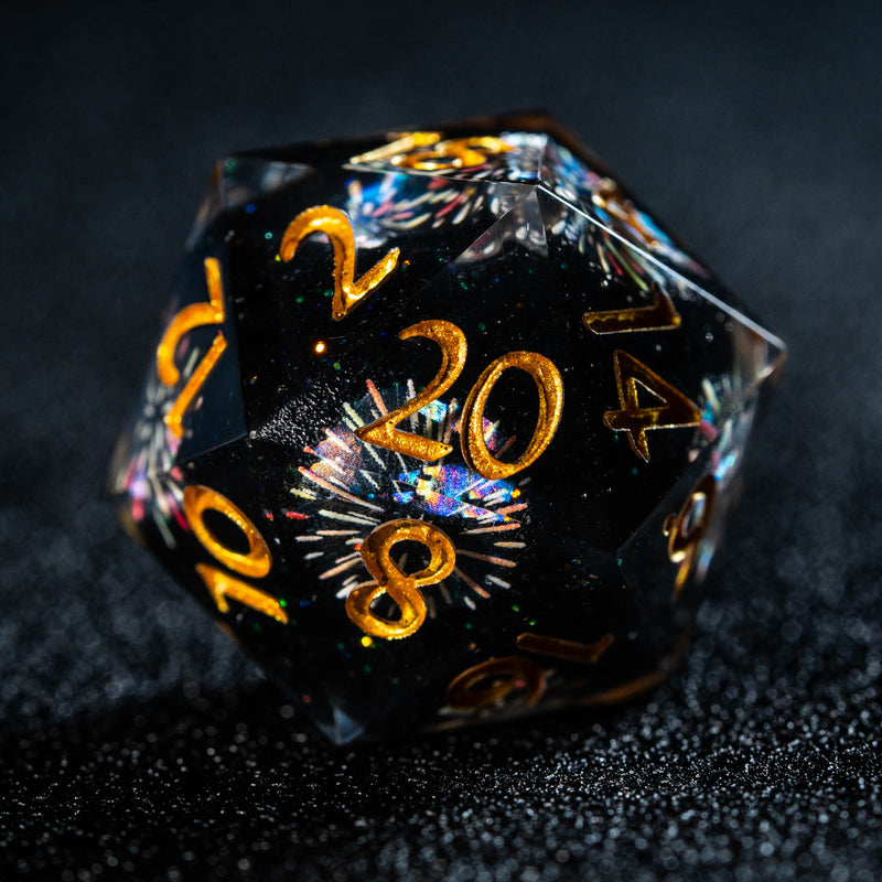 a black dice with gold numbers on it