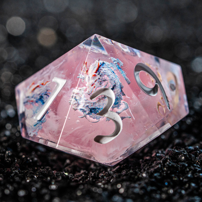 a close up of a pink dice with numbers on it