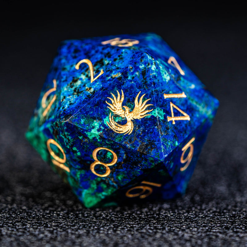 a blue and green dice with gold numbers on it