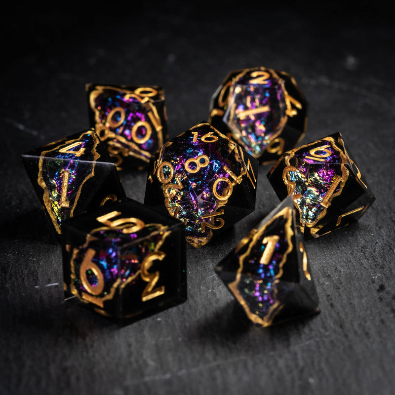 a group of black and gold dices sitting on top of a table