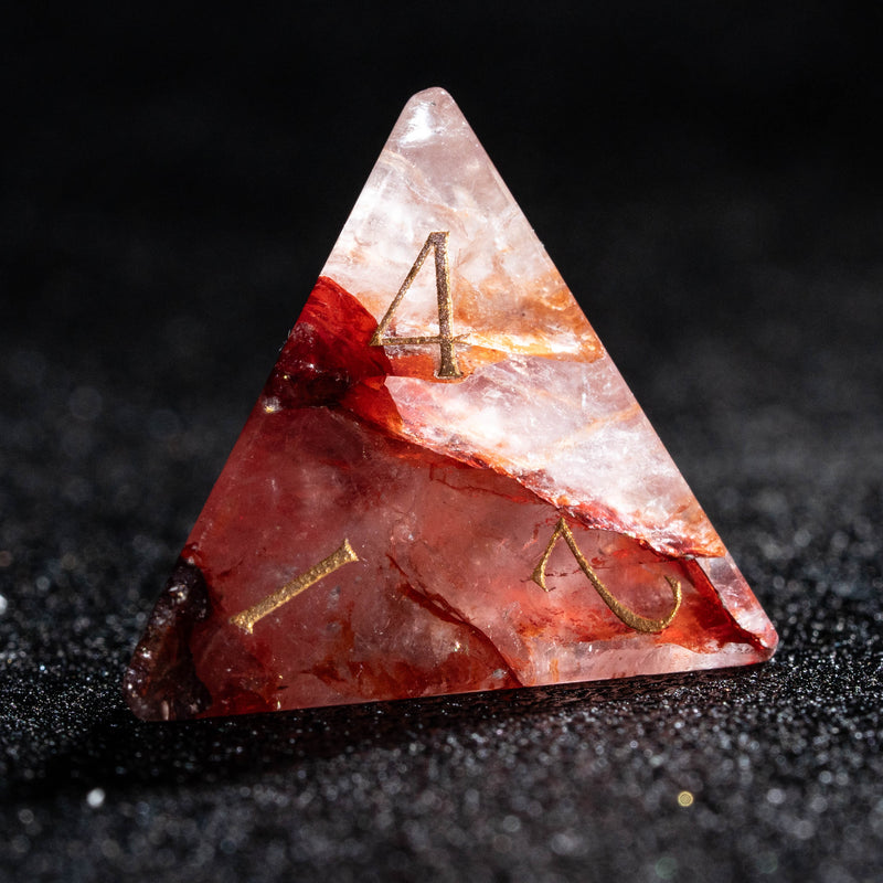 a triangle shaped red rock with gold lettering on it