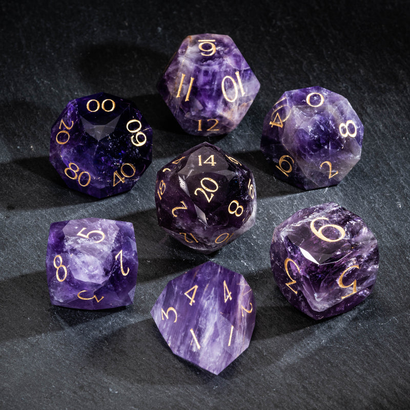 a group of purple and gold dices on a table