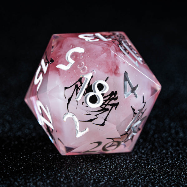 a pink dice with white numbers on it