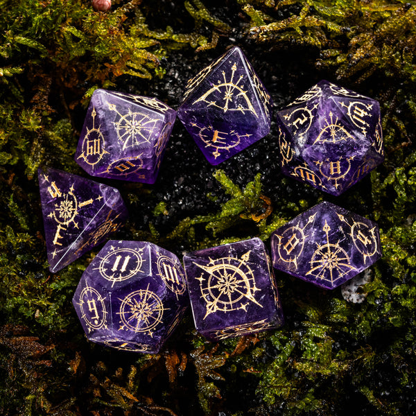 a group of purple dice sitting on top of a moss covered ground