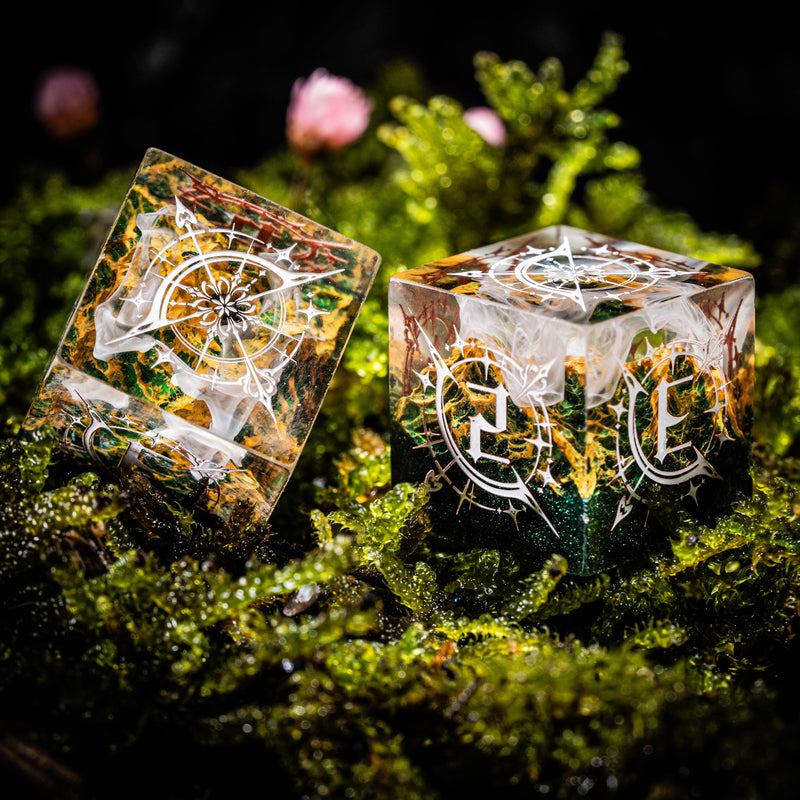 a couple of dices sitting on top of a moss covered ground