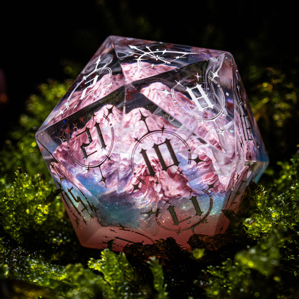 a close up of a pink and black dice