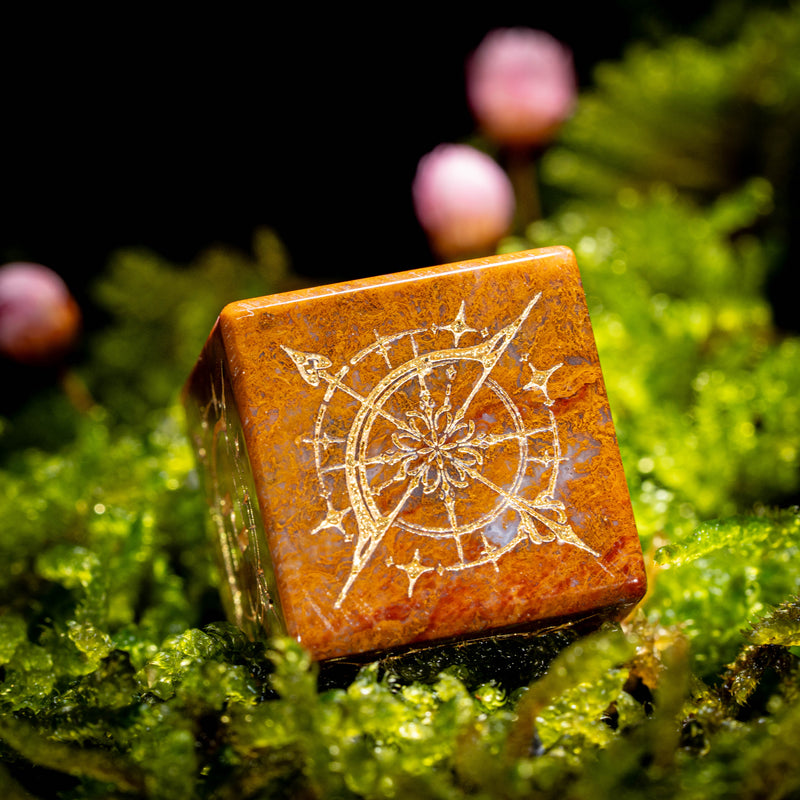 a small wooden object sitting on top of a moss covered ground