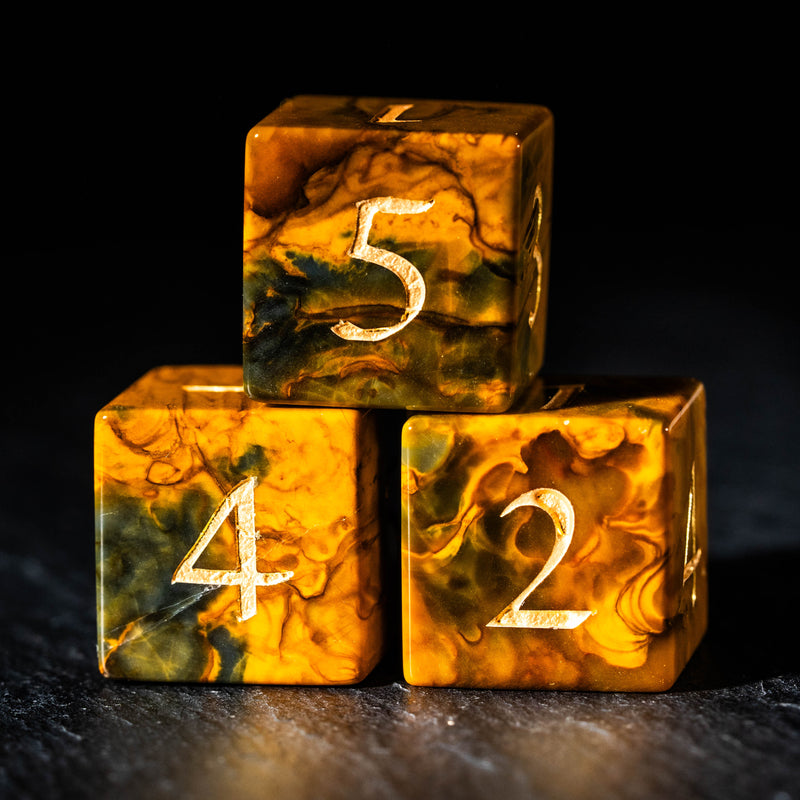 a yellow marbled dice with numbers on it