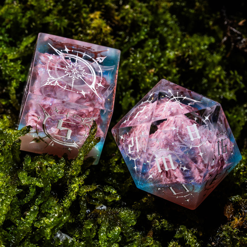 a couple of pink dices sitting on top of a lush green field