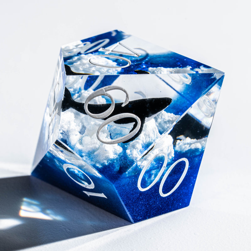a blue and white dice sitting on top of a table