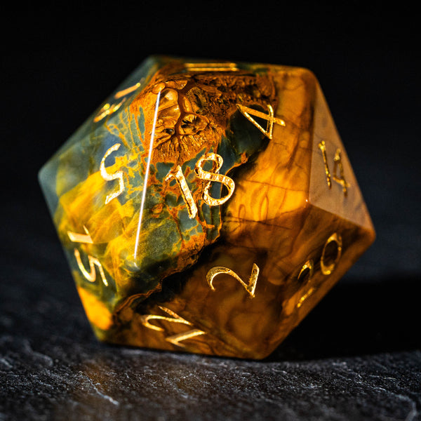 a yellow and green dice sitting on top of a table