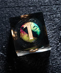 a ring with a letter on it sitting on a black surface