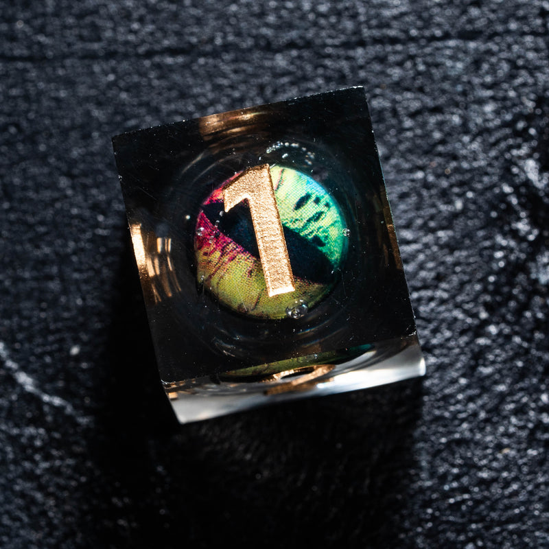 a ring with a letter on it sitting on a black surface