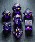 a group of purple and gold dice sitting on top of a table